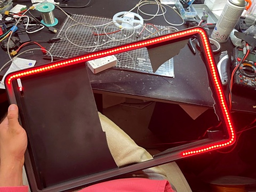 Genboard LED strip assembly — red LEDs being installed into the display frame